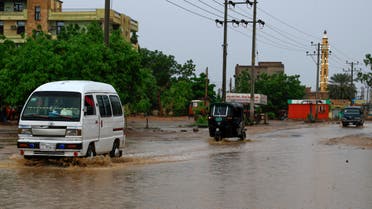 Cars drive along a flooded street in Khartoum after torrential rain fell on the Sudanese capital, almost paralising traffic, on August 8, 2021. Flashfloods due to heavy rains swept through Sudan today, overwhelming the country's already poor drainage systems, and reportedly destroying hundreds of homes in other parts.