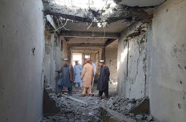  Afghans inspect a damaged clinic after airstrikes in Lashkar Gah city of Helmand province, southern of Kabul, Afghanistan, Sunday, Aug. 8, 2021. Airstrikes in southern Afghanistan damaged a health care clinic and high school in the capital of Helmand province, a provincial council member said Sunday. (AP)