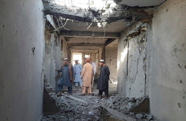 Afghans inspect a damaged clinic after airstrikes in Lashkar Gah city of Helmand province, southern of Kabul, Afghanistan, Sunday, Aug. 8, 2021. Airstrikes in southern Afghanistan damaged a health care clinic and high school in the capital of Helmand province, a provincial council member said Sunday. (AP)