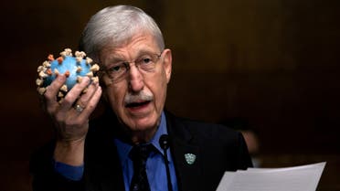 FILE PHOTO: National Institutes of Health Director Francis S. Collins holds a model of SARS-CoV-2, the novel coronavirus, as he testifies on Capitol Hill in Washington, D.C., U.S., July 2, 2020. Graeme Jennings/Pool via REUTERS/File Photo