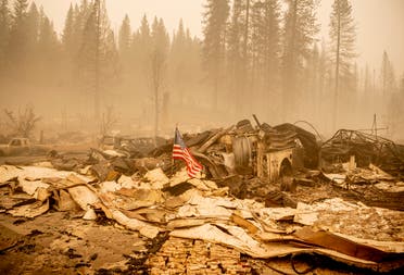 An American flag is placed on a burned fire engine at a burned fire station in downtown Greenville, California on August 7, 2021. (AFP)