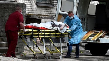 A file photo shows two nurses carry a patient at the Botkin hospital for infectious diseases, Saint Petersburg’s main coronavirus treatment center, June 3, 2020. (Olga Maltseva/AFP)