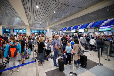 Russian tourists gather at the Egyptair check-in desk at the Domodedovo International Airport outside Moscow, Russia, Monday, Aug. 9, 2021. (AP)