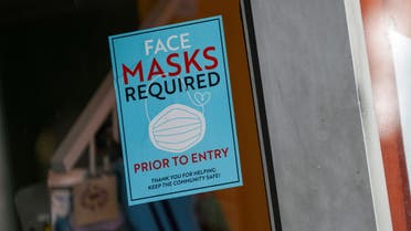 A sign at the entry to a beauty salon informs of mask requirement due to COVID-19 measures in New York City, July 27, 2021. (Reuters)