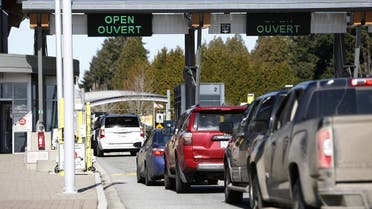 A file photo shows drivers wait to cross through Canadian customs at the Canada-US border near the Peace Arch Provincial Park in Surrey, British Columbia, Canada. Canada March 16, 2020. (Reuters/Jesse Winter)