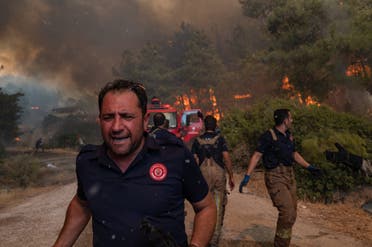 Firefighters battle a wildfire on August 2, 2021 in Mugla, Marmaris district, as the European Union sent help to Turkey and volunteers joined firefighters in battling a week of violent blazes. (AFP)