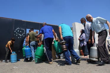 لبنانيون ينتظرون ملء قوارير الغاز في صيدا يوم 10 أغسطس (فرانس برس)