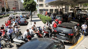 Motorbike and car drivers wait to get fuel at a gas station in Beirut, June 29, 2021. (Reuters)