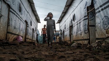 Internally displaced children run in an alley of a camp in the town of Azezo, Ethiopia, on July 12, 2021. (Eduardo Soteras/AFP)