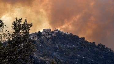Smoke rises from a wildfire in the forested hills of the Kabylie region, east of the capital Algiers, on August 10, 2021. (Ryad Kramdi/AFP)