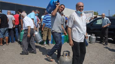 Lebanese wait to fill their gas cylinders in the southern city of Sidon amidst a deepening economic crisis, on August 10, 2021. (AFP)