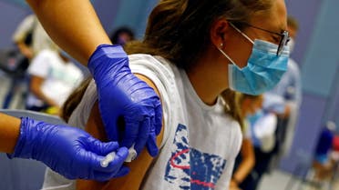 A nurse administers the first dose of the Moderna vaccine against coronavirus disease (COVID-19) to 15-year-old Tatiana Suarez at a vaccination centre in Meloneras on the island of Gran Canaria, Spain, July 28, 2021. (Reuters)
