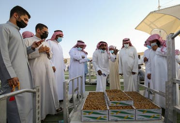 Saudi farmer displays dates to customers during Unaizah Season for Dates, at Unaizah city in Al-Qassim province, Saudi Arabia August 10, 2021. Picture taken August 10, 2021. (Reuters)