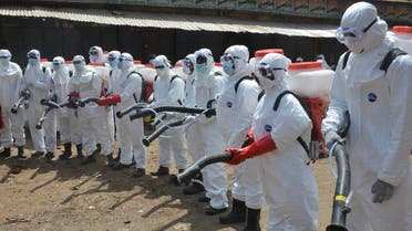 Workers dressed in full body gear prepares to disinfect shops and streets in Conakry, Guinea, on April 12, 2020 during a cleaning and disinfecting campaign as a preventive measure against the spread of the COVID-19 coronavirus. (File photo: AFP)