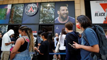 Fans queue in front of a Paris St Germain shop in Paris to buy Paris St Germain Lionel Messi football jerseys, France, on August 11, 2021. (Reuters)