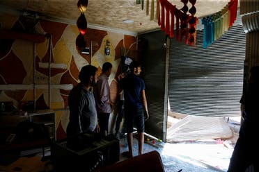 A Syrian shop owner and his friends check the damage in his shop after a crowd of Turks attacked shops and homes belonging to Syrians overnight, in the wake of a street fight that led to a Turkish youth being fatally stabbed, in Ankara, Turkey August 12, 2021. (Reuters)