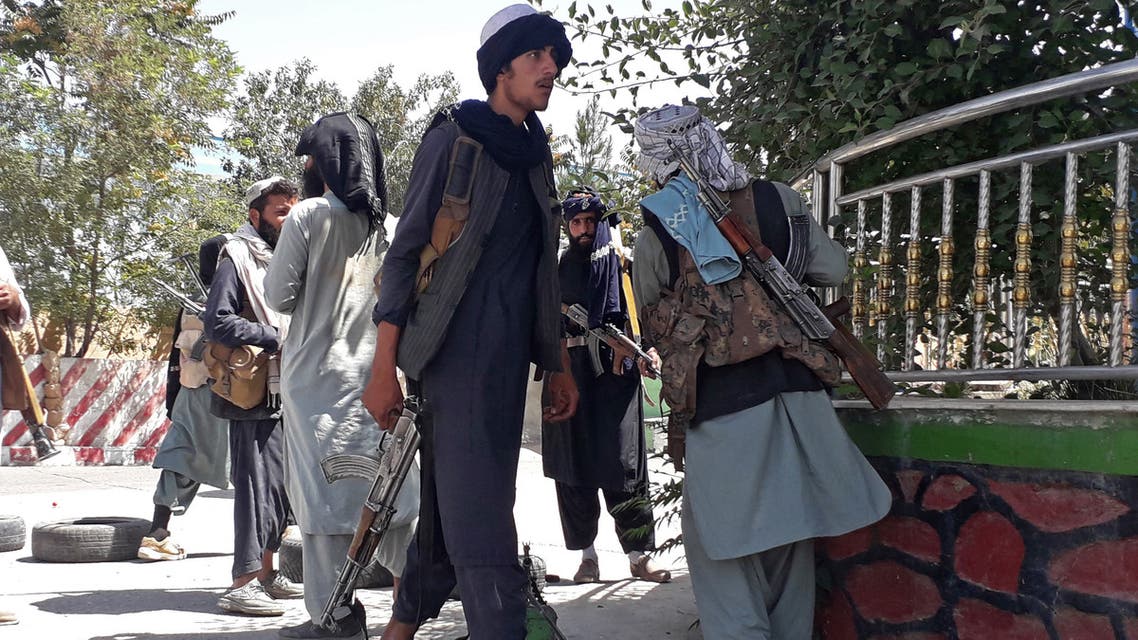 Taliban fighters stand along the roadside in Ghazni on August 12, 2021, as Taliban move closer to Afghan capital after taking Ghazni city.
