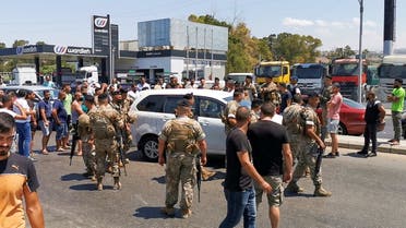 Lebanese army soldiers try to open a road blocked by cars near a gas station in Sidon, Lebanon August 12, 2021. (Reuters)