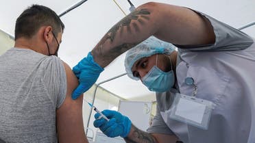 A migrant worker receives a jab while being injected with the one-dose Sputnik Light vaccine against the coronavirus  in a vaccination center at a city market in Moscow, Russia, on June 30, 2021. (Reuters)