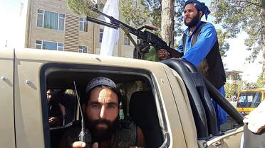 Taliban fighters are pictured in a vehicle along the roadside in Herat, Afghanistan's third biggest city, after government forces pulled out the day before following weeks of being under siege.