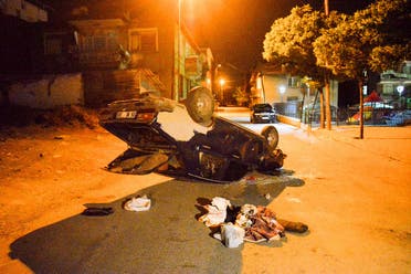 A damaged vehicle lies on a street after a Turkish mob attacked shops and homes said to belong to Syrian migrants in Ankara early August 12, 2021, in the wake of a street fight that led to a Turkish youth being fatally stabbed. (AFP)