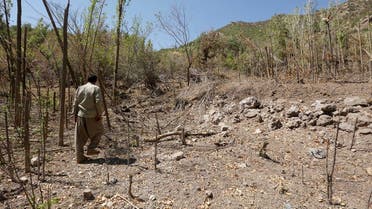 File photo of a resident walking past a crater caused by a Turkish airstrike against Kurdistan Workers Party (PKK) in Sigire on the outskirts of Dohuk province. (Reuters)