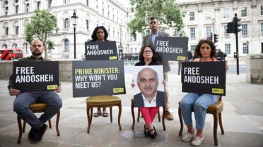 Sherry Izadi, Elika Ashoori and Aryan Ashoori, the family of Anoosheh Ashoori, a British man currently jailed in Iran, joined by Amnesty International CEO Sacha Deshmukh and MP Janet Daby, stage an 'empty chair' protest opposite Downing Street, on the 4th anniversary of his imprisonment, in London, Britain. (Reuters)