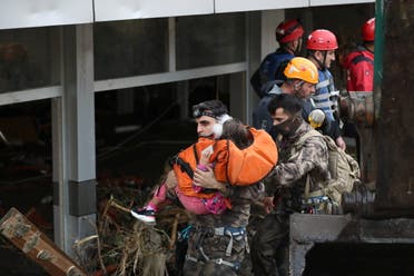 Search and Rescue team members evacuate a girl during flash floods which have swept through towns in the Turkish Black Sea region, in Bozkurt, a town in Kastamonu province, Turkey, August 12, 2021. (Reuters)