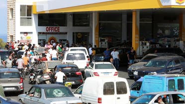 Motorbike and car drivers wait to get fuel at a gas station, after the central bank decided to effectively end subsidies on fuel imports, in Damour, Lebanon, August 13, 2021. (Reuters)