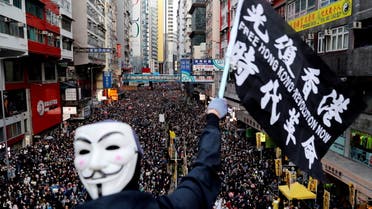 A protester wearing a Guy Fawkes mask waves a flag during a Human Rights Day march, organised by the Civil Human Right Front, in Hong Kong, China December 8, 2019. (File Photo: Reuters)