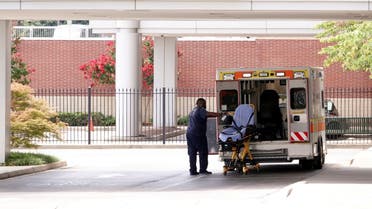 An ambulance driver disinfects a stretcher after unloading a patient at a Memphis children’s hospital, in Memphis, Tennessee, US August 13, 2021. (Reuters/Karen Pulfer Focht)