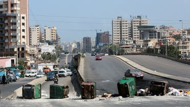 Garbage bins placed by protesters block a road, as fuel crisis worsens, in Beirut, Lebanon August 14, 2021.  (Reuters)