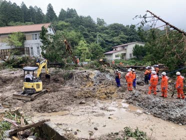 Rescue workers search for missing people at a landslide site caused by heavy rainfall in Unzen, Nagasaki Prefecture, southwestern Japan, in this handout image taken and released by Unzen City August 15, 2021. (Reuters)