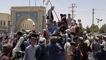 Taliban fighters stand on a vehicle along the roadside in Kandahar on August 13, 2021. (AFP)