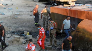 Lebanese army soldiers, civil defense members and rescuers are seen at the site of a fuel tanker explosion in Akkar, in northern Lebanon, August 15, 2021. (Reuters)