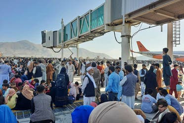 Afghans crowd at the tarmac of the Kabul airport on August 16, 2021, to flee the country as the Taliban were in control of Afghanistan after President Ashraf Ghani fled the country and conceded the insurgents had won the 20-year war. (AFP)