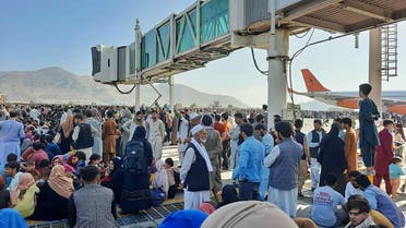 Afghans crowd at the tarmac of the Kabul airport on August 16, 2021, to flee the country as the Taliban were in control of Afghanistan after President Ashraf Ghani fled the country and conceded the insurgents had won the 20-year war. (AFP)