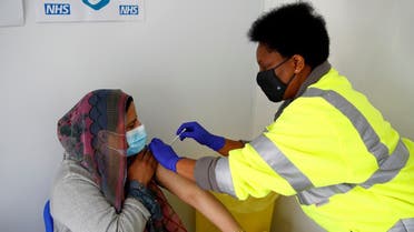 Nasreen Akhtar, 35, receives a dose of Pfizer vaccine against COVID-19 at a vaccination centre in Pharmacy 4 U, amid the outbreak of the coronavirus disease (COVID-19), in Blackburn, Britain, May 19, 2021. REUTERS