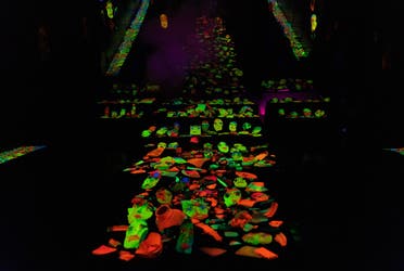 An altar-like arrangement of faces where the lighting makes them glow from inside.