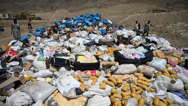 Daily workers and security forces prepare to set on fire a pile of narcotics during the National Mobilization Week against Drug Abuse and Illicit Trafficking, in the Deh Sabz district of Kabul on July 1, 2021. (File photo: AFP)