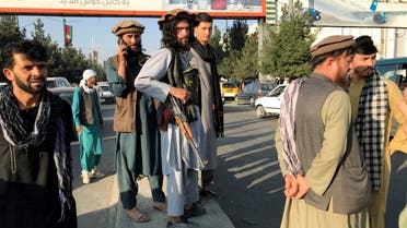 A member of Taliban (C) stands outside Hamid Karzai International Airport in Kabul, Afghanistan, August 16, 2021. (Reuters)
