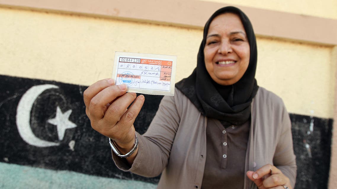 A Libyan woman displays her voting ID during legislative elections at a polling station in the eastern city of Benghazi on June 25, 2014. Polling was under way across Libya in a general election seen as crucial for the future of a country hit by months of political chaos and growing unrest. Voters are choosing from among 1,628 candidates, with 32 seats in the 200-strong General National Congress reserved for women and would-be MPs banned from belonging to any political party.