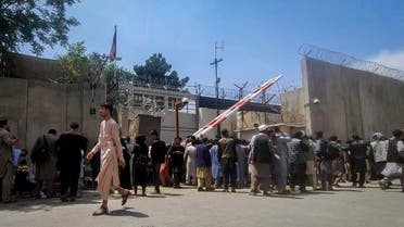 Afghan people gather outside the French embassy in Kabul on August 17, 2021 waiting to leave Afghanistan. (AFP)