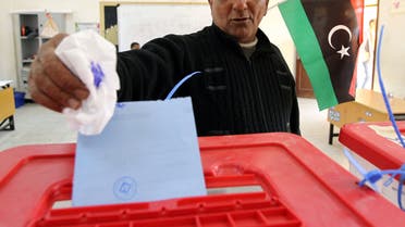 A Libyan man casts his vote to elect a constituent assembly at a polling station in the eastern city of Benghazi on February 20, 2014. Libyans went to the polls today to elect a constitution-drafting panel in the latest milestone in the chaotic political transition from the ousted dictatorship of Moamer Kadhafi. AFP PHOTO/ABDULLAH DOMA