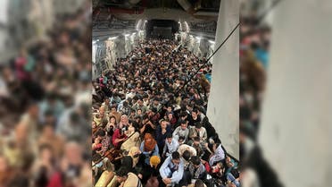 Evacuees crowd the interior of a US Air Force C-17 Globemaster III transport aircraft, carrying some 640 Afghans to Qatar from Kabul, Afghanistan August 15, 2021. (Reuters)