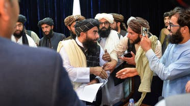 Taliban spokesperson Zabihullah Mujahid (C) leaves after addressing the first press conference in Kabul on August 17, 2021 following the Taliban stunning takeover of Afghanistan.