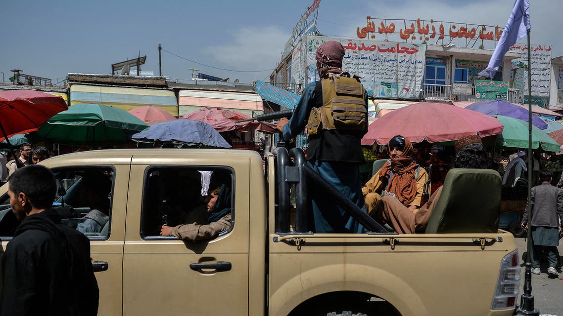 Taliban fighters on a pick-up truck move around a market area, flocked with local Afghan people at the Kote Sangi area of Kabul on August 17, 2021, after Taliban seized control of the capital following the collapse of the Afghan government. (File photo: AFP)