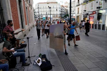 Spanish artist Antonio Lopez carries the canvas on which he is painting the famous Puerta del Sol square after a session in Madrid, Spain, August 5, 2021. Picture taken August 5, 2021. REUTERS/Juan Medina