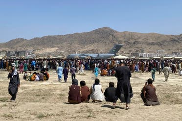 Hundreds of people gather near a US Air Force C-17 transport plane at a perimeter at the international airport in Kabul, Afghanistan, Monday, Aug. 16, 2021. (AP)