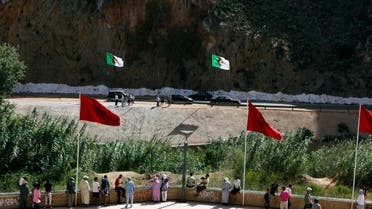 People stand near a border post on the Algerian side of the Morocco-Algeria border in the north east of Morocco. (Reuters)